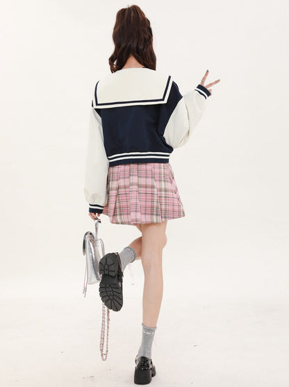 Navy-colored short stadium jacket + checked skirt