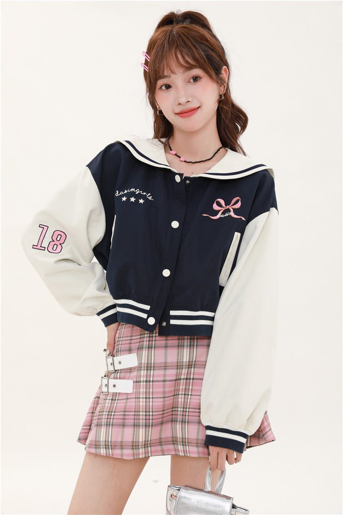 Navy-colored short stadium jacket + checked skirt