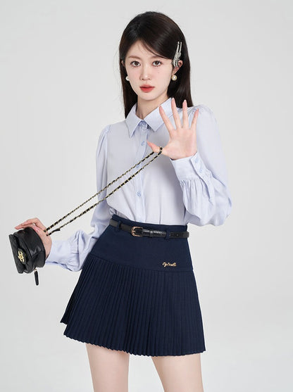 Navy-colored blue shirt + pleated skirt