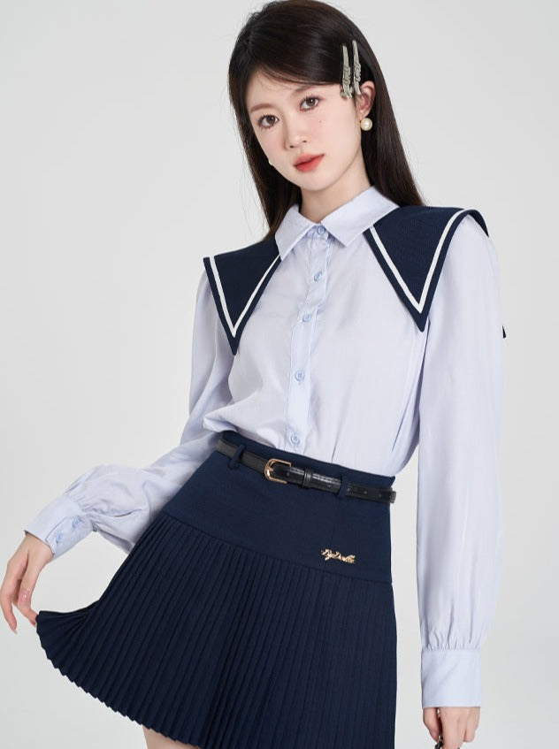 Navy-colored blue shirt + pleated skirt