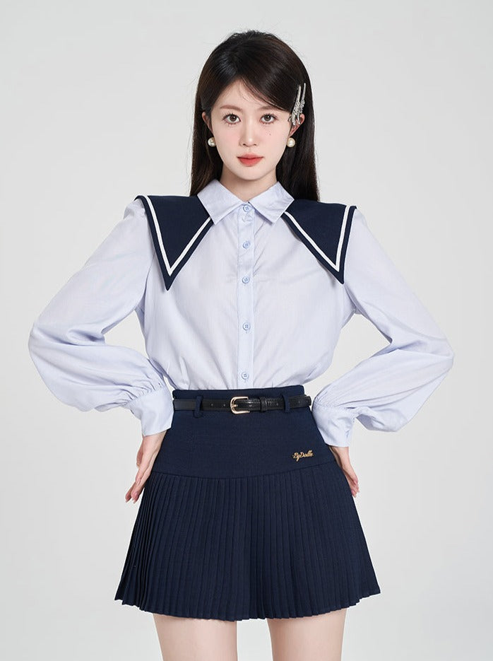 Navy-colored blue shirt + pleated skirt