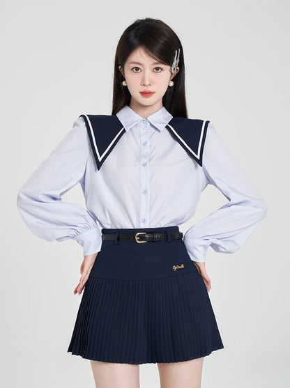 Navy-colored blue shirt + pleated skirt