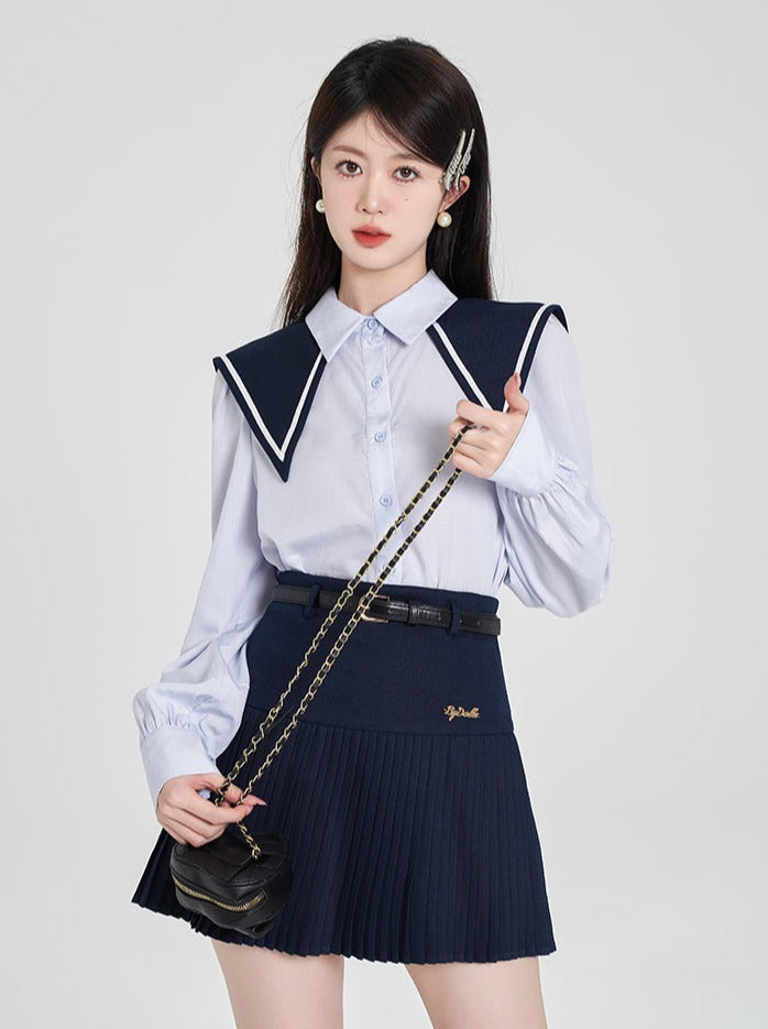 Navy-colored blue shirt + pleated skirt