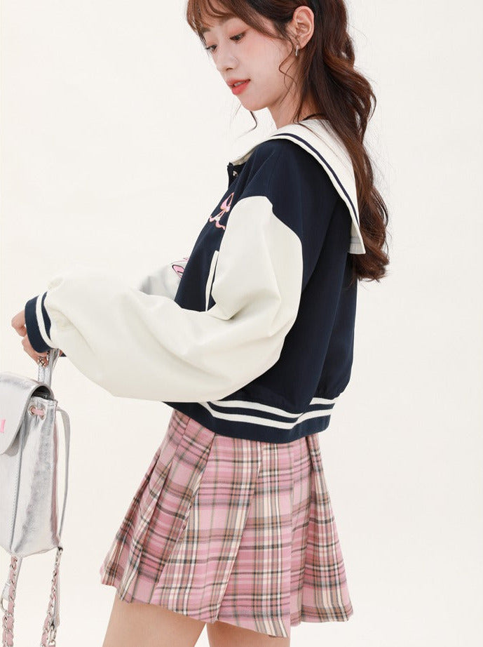 Navy-colored short stadium jacket + checked skirt