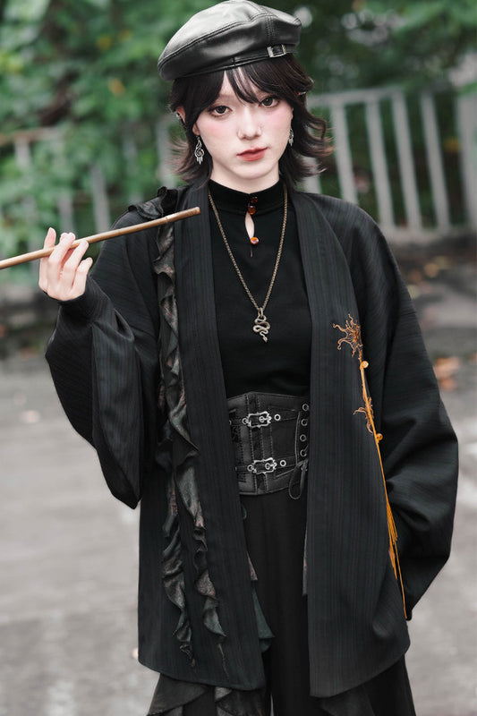 Lockere schwarze Strickjacke mit Spitzenbesatz, Stickerei und Quasten